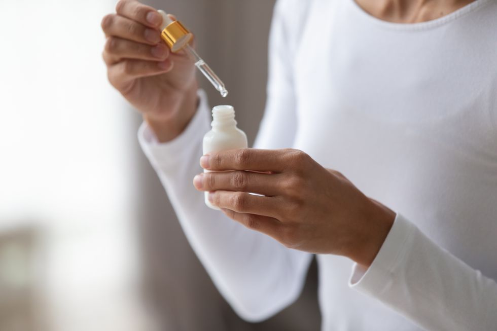 close-up-young-woman-holding-bottle-with-pipette-royalty-free-image-1588153780.jpg